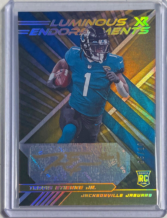 TRAVIS ETIENNE JR. 2021 PANINI XR LUMINOUS ENDORSEMENTS GOLD AUTO RC #D 06/10